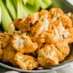 buffalo cauliflower wings on plate with celery