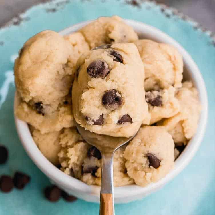 edible cookie dough in bowl with spoon and chocolate chips