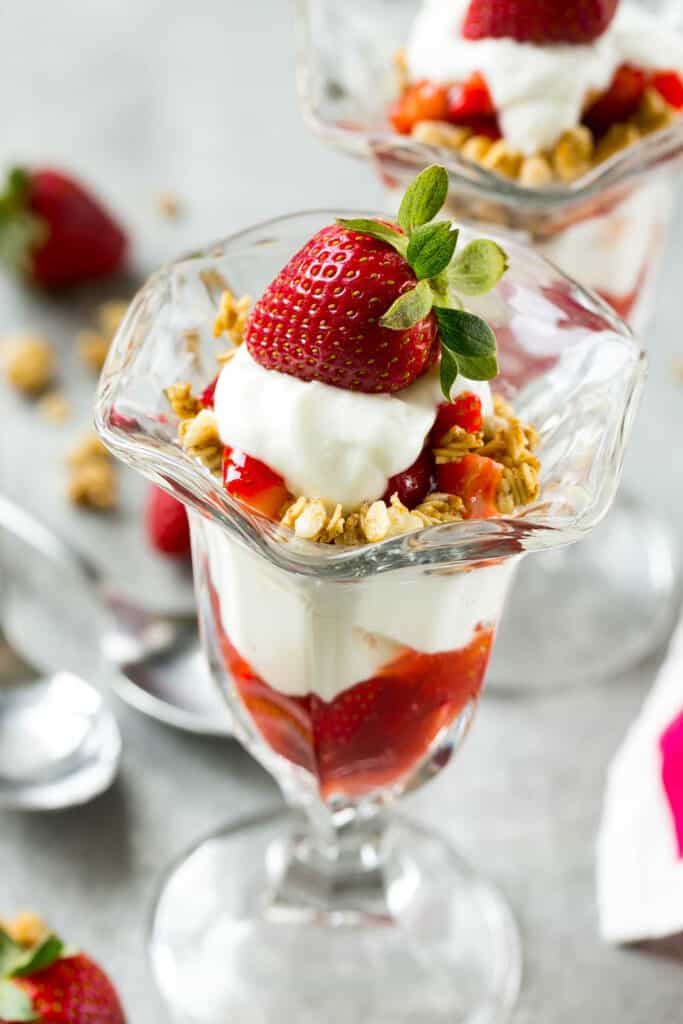 side shot of strawberry parfait topped with fresh strawberry