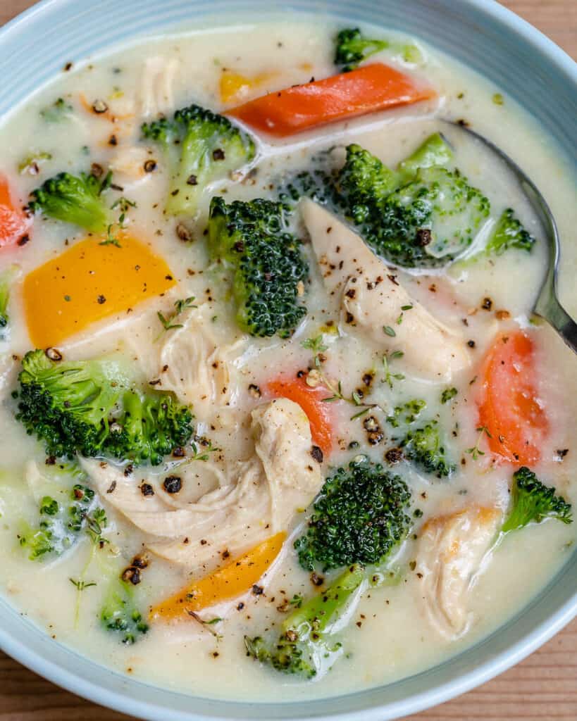 close up image of a chicken broccoli soup recipe in a bowl