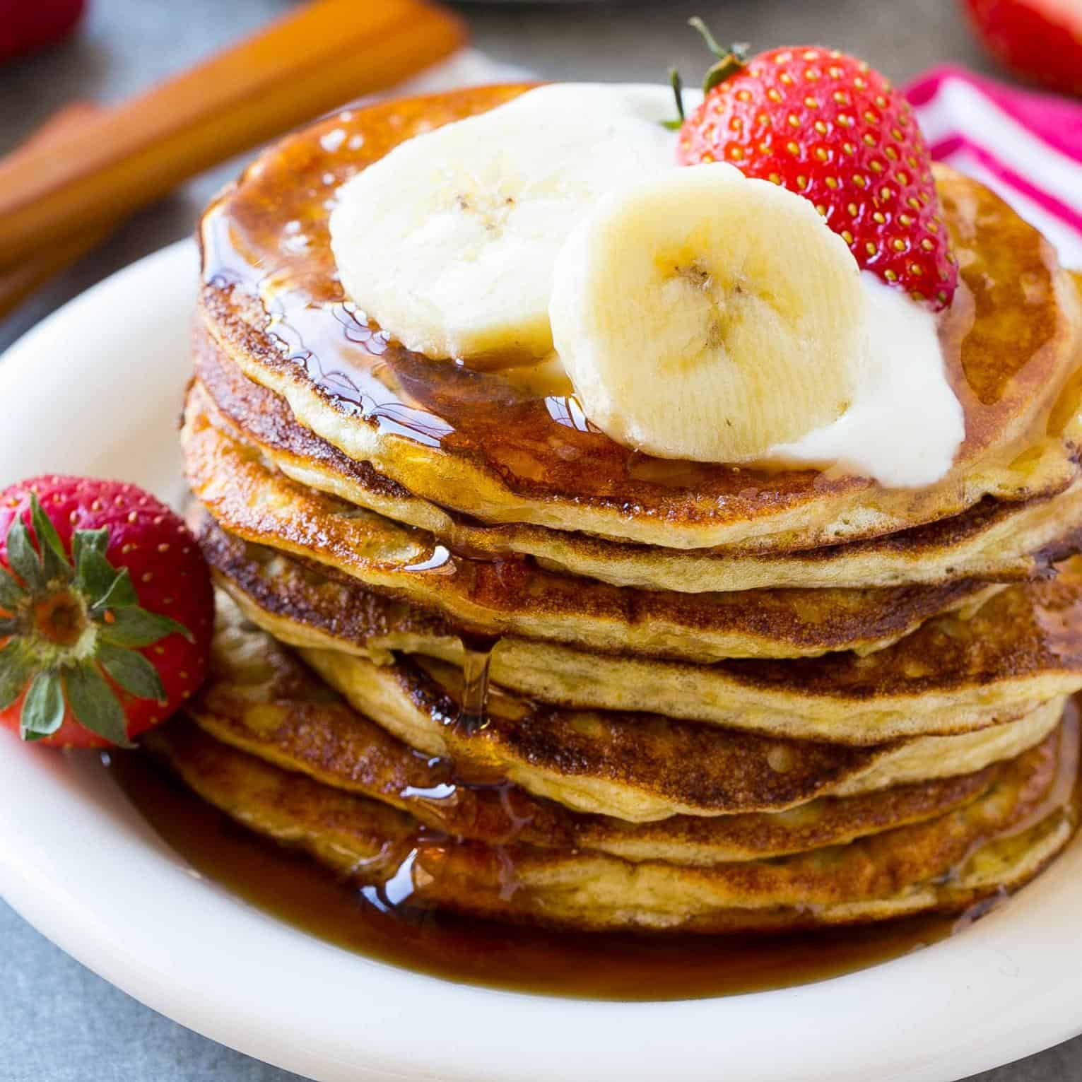 banana pancakes on plate with fresh fruit