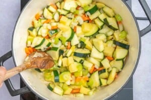 sauteed veggies in a pot to make soup.