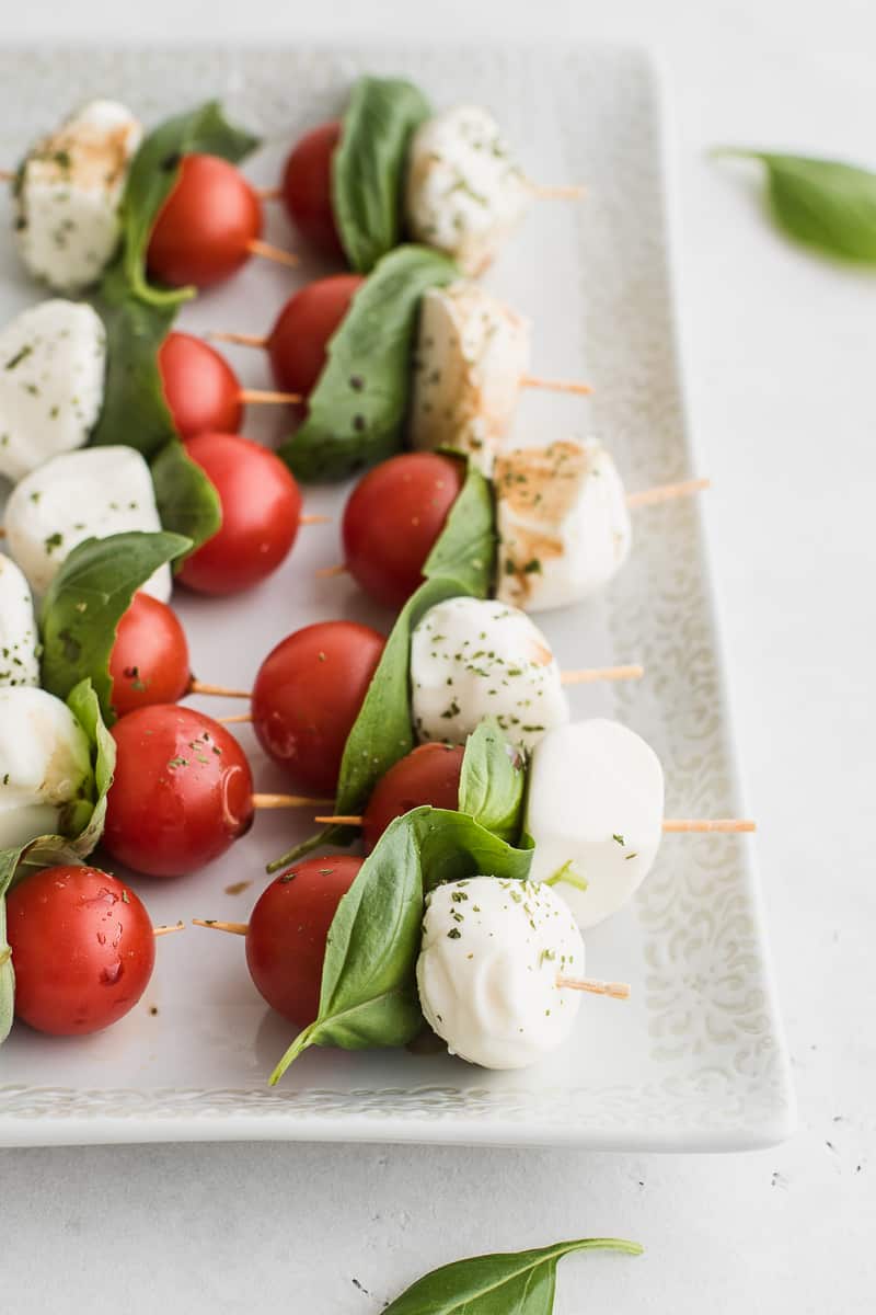 cherry tomato, basil leaf and cheese balls on a skewer