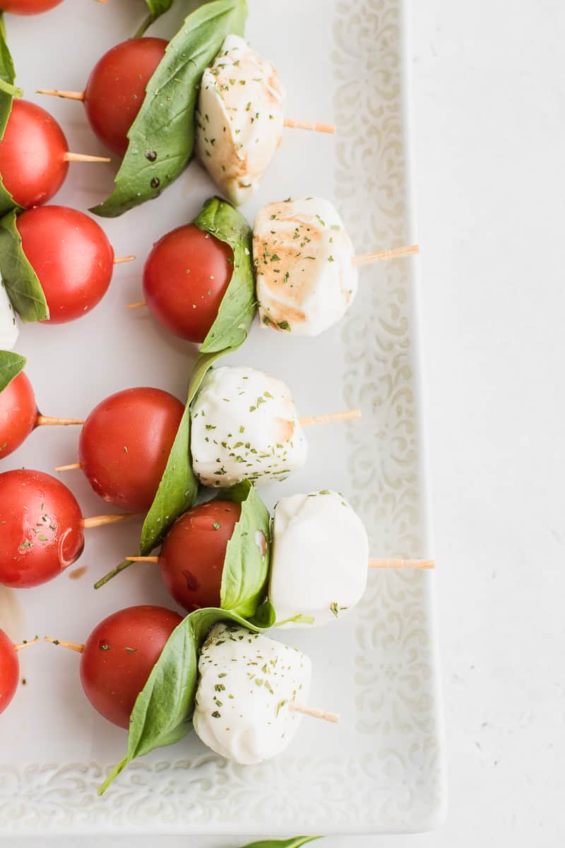 cherry tomato, basil leaf and mozzarella balls on a skewer