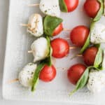 cherry tomato, basil leaf and mozzarella balls on a skewer