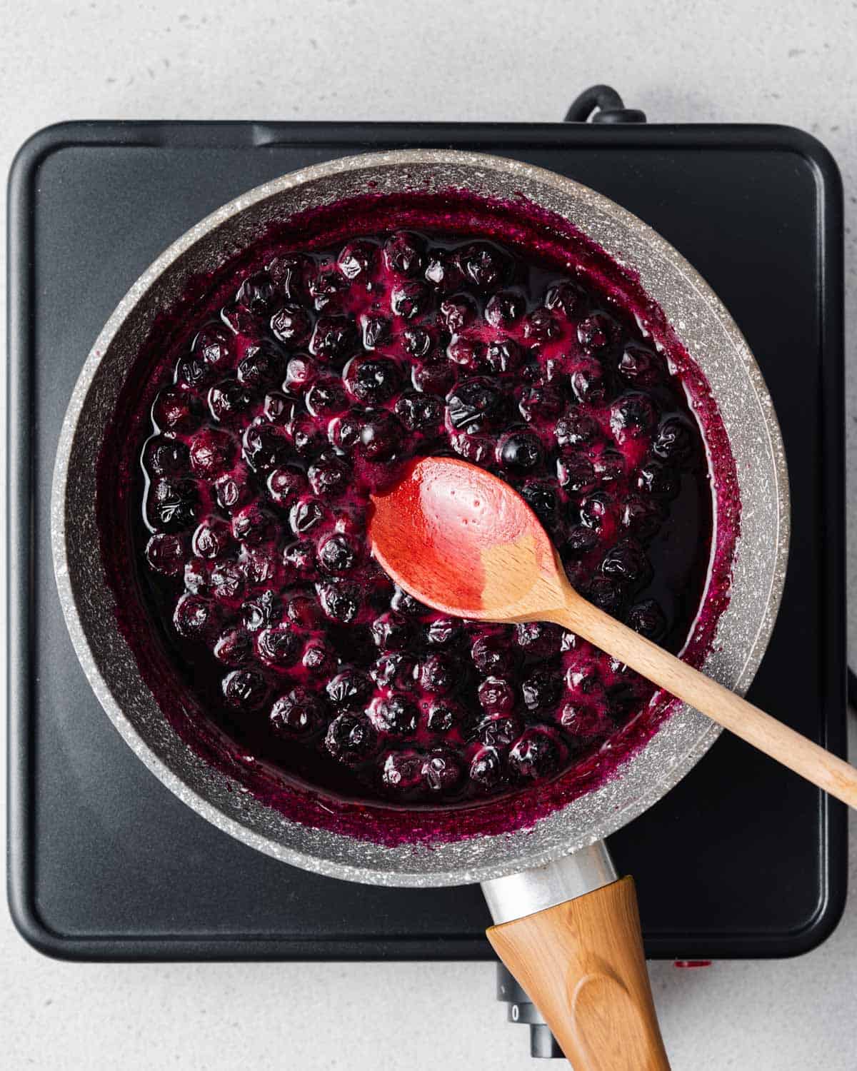 cooked blueberries in a pan.