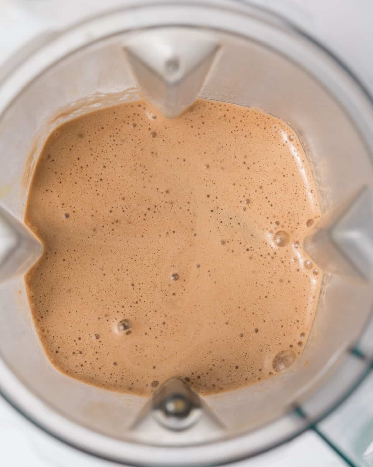 blended ingredients to make a mocha protein shake in a blender.