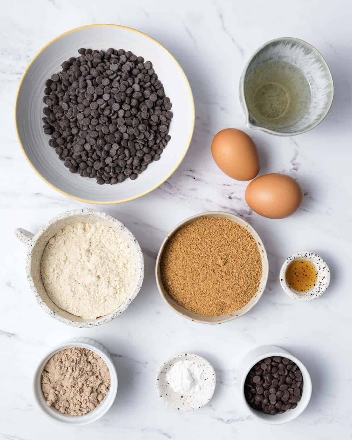 ingredients to make protein brownies in small bowls.