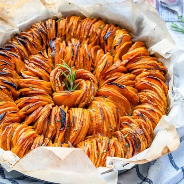 roasted sweet potato slices placed in a spiral form on a pan.