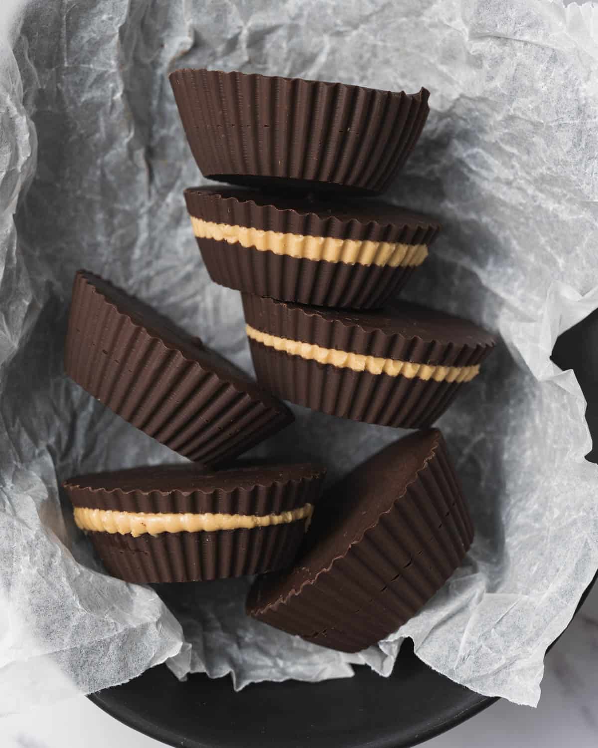 peanut butter cups placed in a dish over parchment paper.