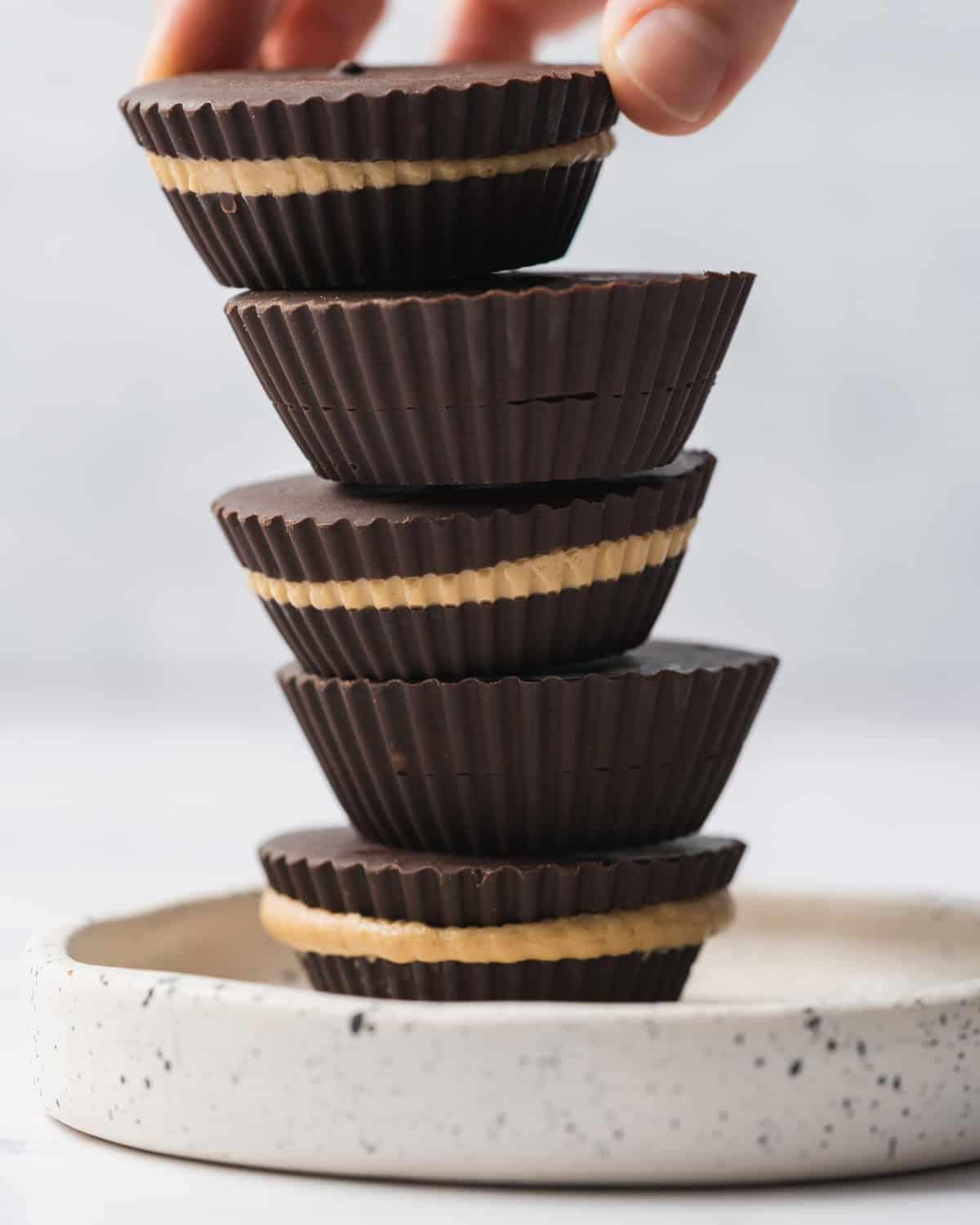 peanut butter cups stacked over each other on a plate.