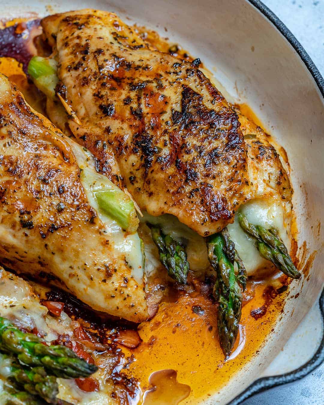 chicken stuffed with cheese and veggies on a skillet