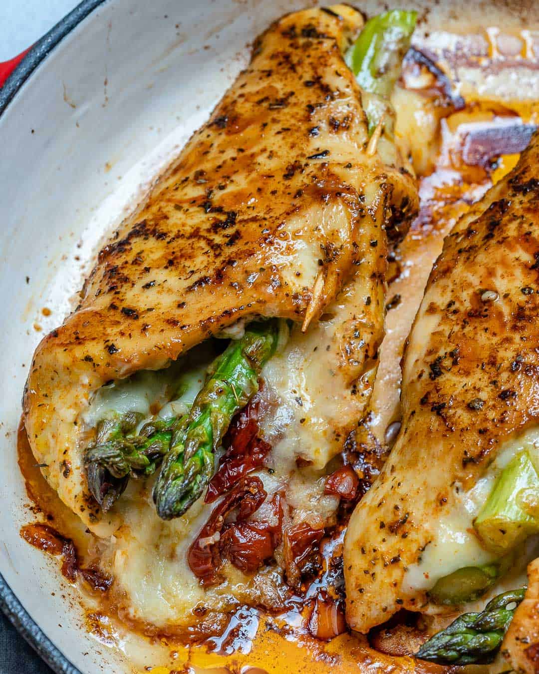 Stuffed chicken breast in a pan.