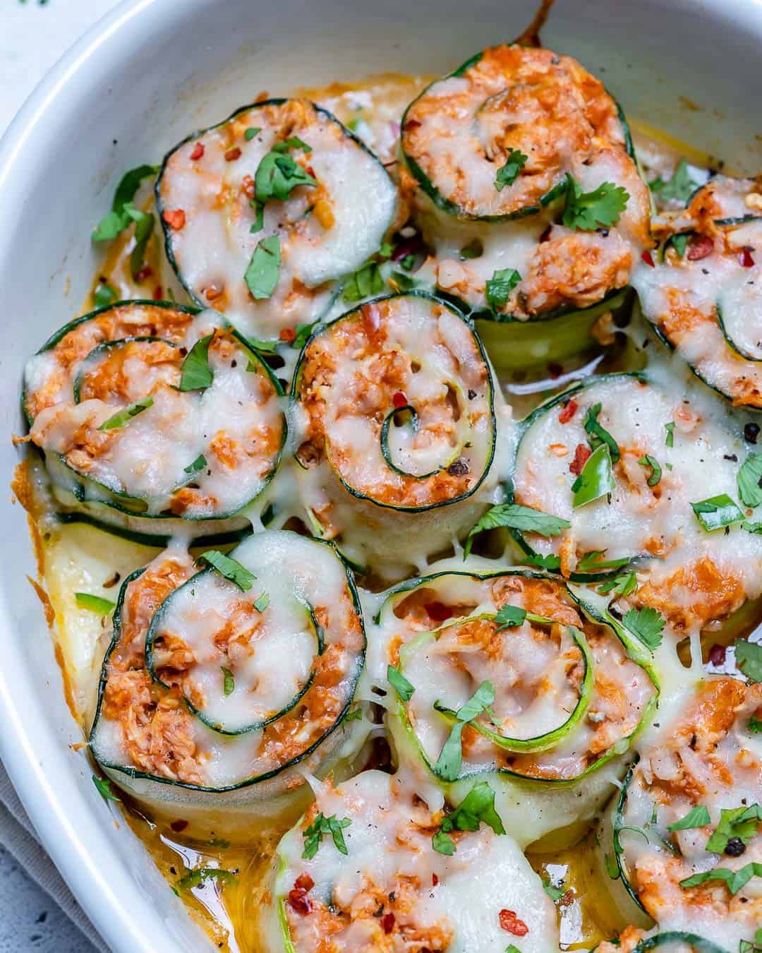 enchilada roll up with chicken stuffing in a white dish