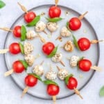 Caprese skewers served on a plate.