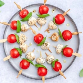 Caprese skewers served on a plate.