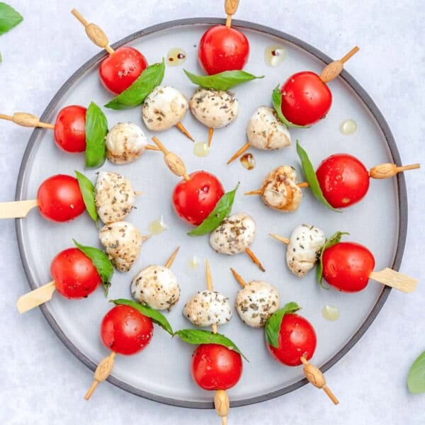 Caprese skewers served on a plate.