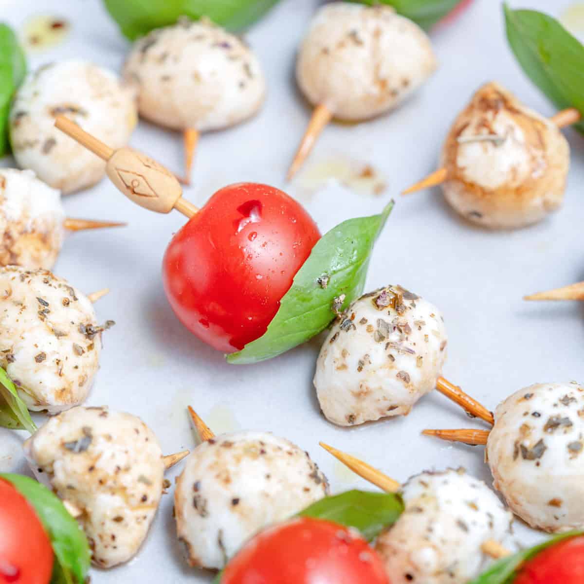 Caprese skewers on a plate.