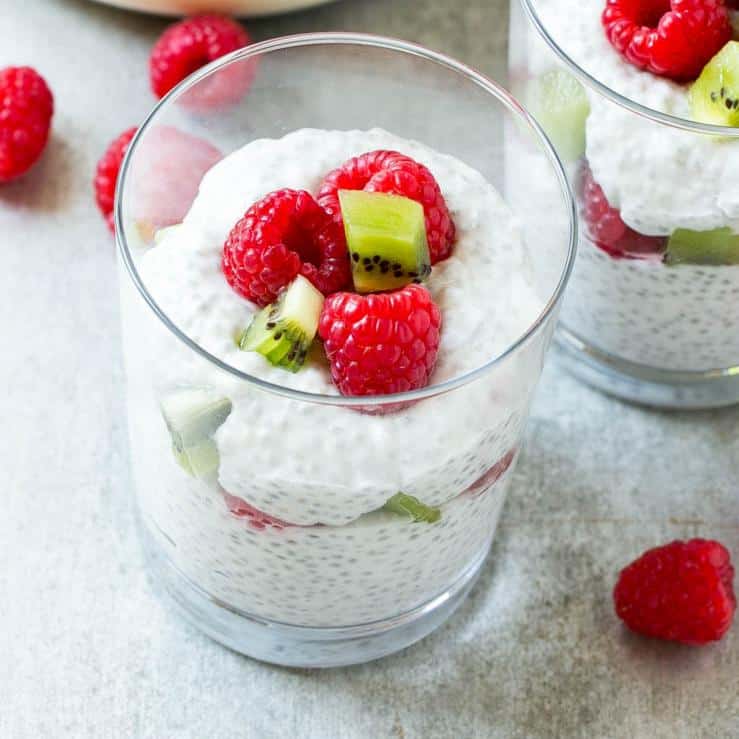 coconut chia pudding recipe with raspberries and kiwi in glass dish