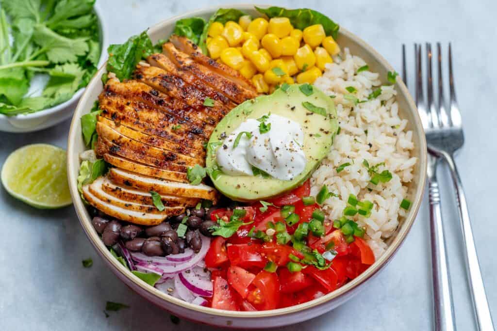 chicken burrito bowl with fork on the right side of the bowl