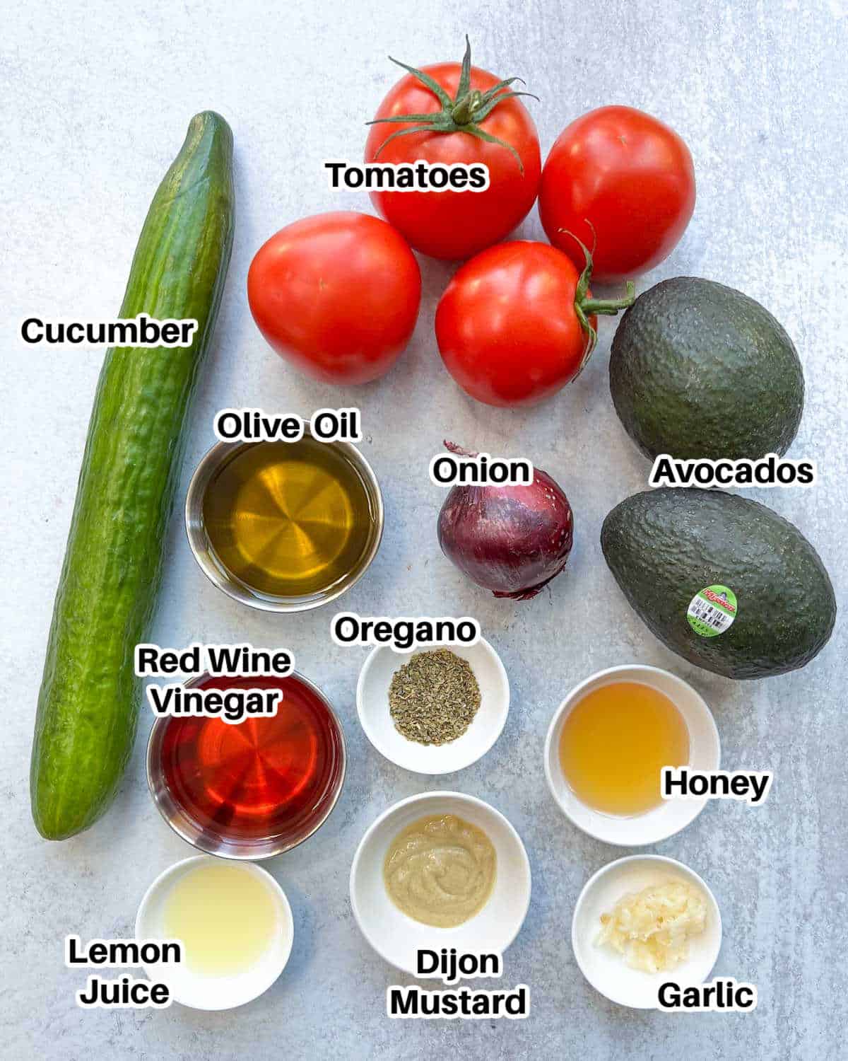 Ingredients to make avocado tomato salad laid out.