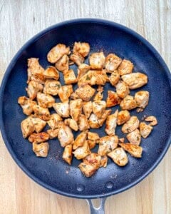 Cooking chicken bites in a pan.