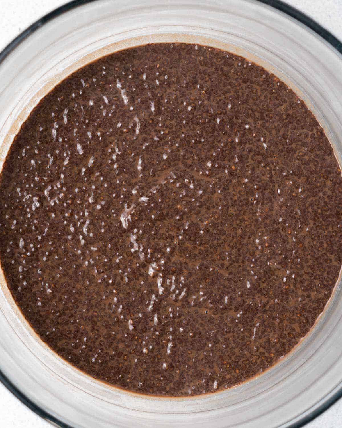 thick chocolate chia pudding a clear bowl.