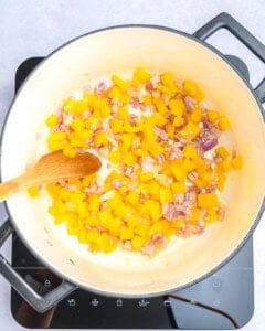 sauteeing the veggies in a pot for corn chowder.