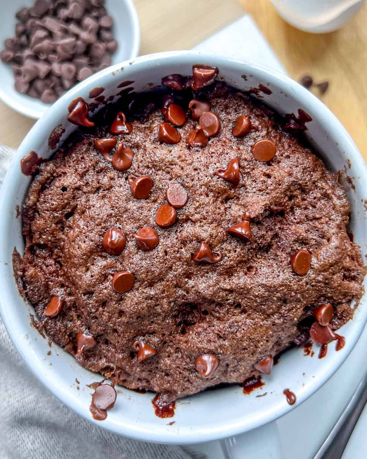 a white mug with chocolate cake in it. 