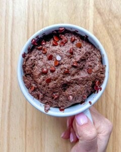 hand holding the cooked chocolate mug cake from the microwave.