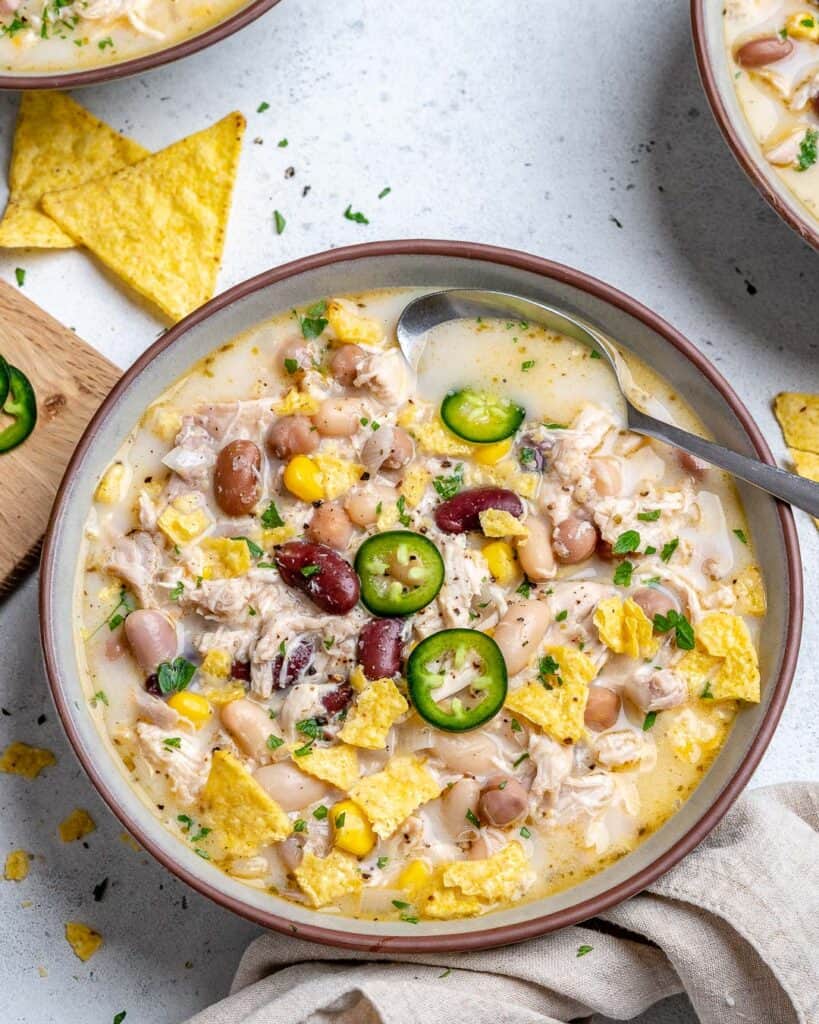bowl of white bean chill topped with sliced jalapenos