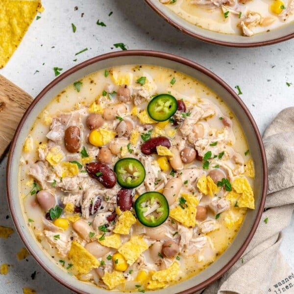 white chicken chili recipe in a round bowl made with 4 different beans