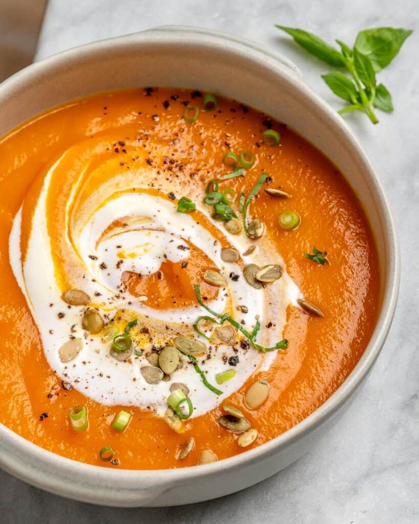 vegan pumpkin soup in a white bowl made of pumpkin and roasted carrots