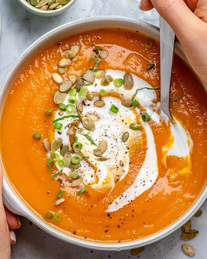 top view vegetarian pumpkin soup recipe with a spoon in bowl
