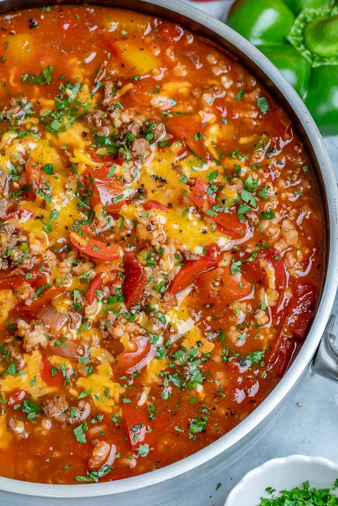 easy stuffed pepper soup recipe on stovetop. Topped with cheese and fresh parsley