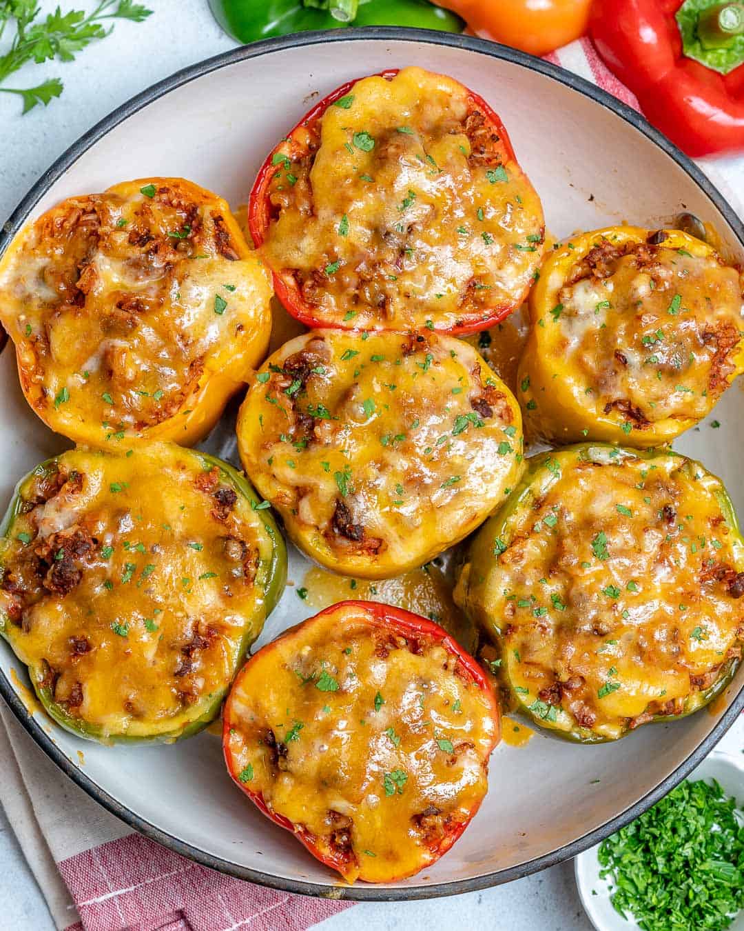 easy stuffed peppers recipe on plate with cheese and parsley 