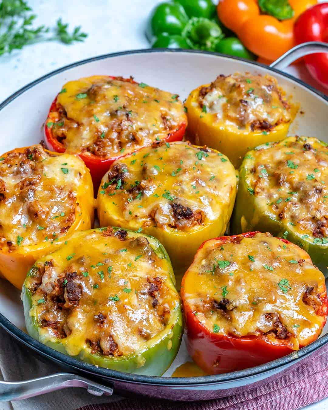 bell peppers with ground beef  in pan with cheese and parsley 