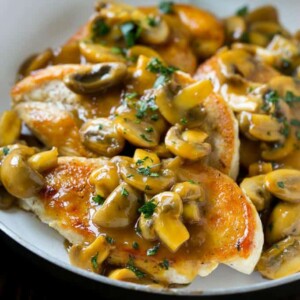 close up image of sauteed chicken breasts topped with mushroom sauce