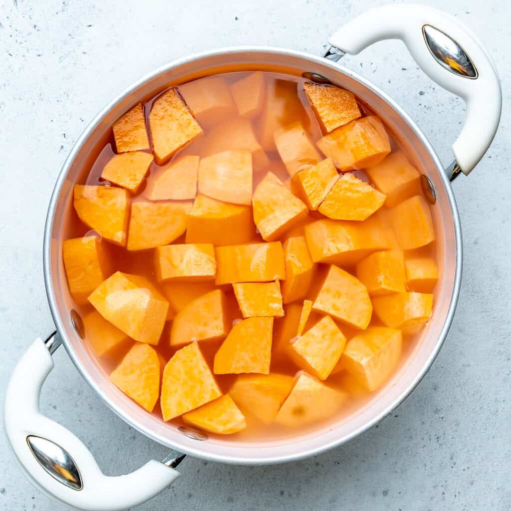 SWEET potato chunks in a pot of water to be boiled
