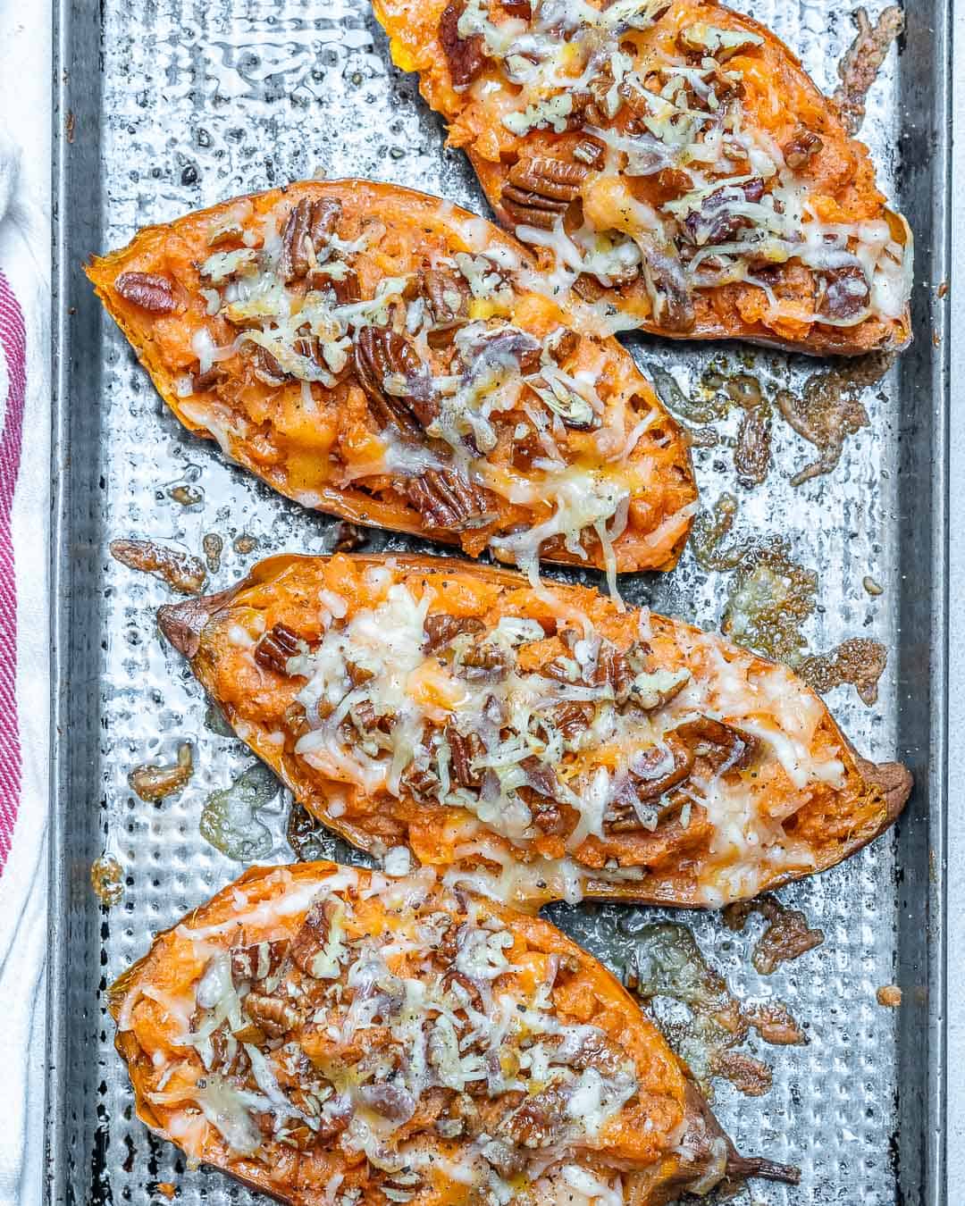 4 sweet potatoes on a baking tray