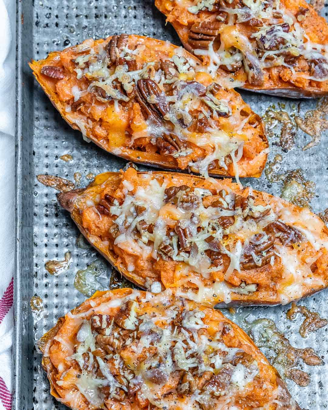 overhead shot of twice baked sweet potatoes on a baking tray with topping