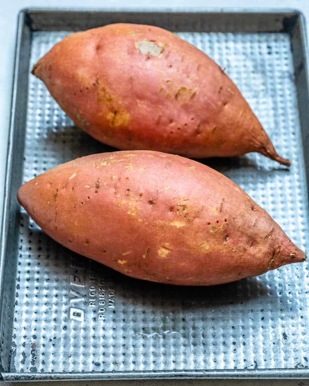two sweet potatoes on a tray