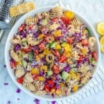 a bowl of pasta salad loaded with veggies and tossed in dressing.