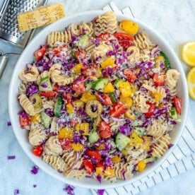 a bowl of pasta salad loaded with veggies and tossed in dressing.