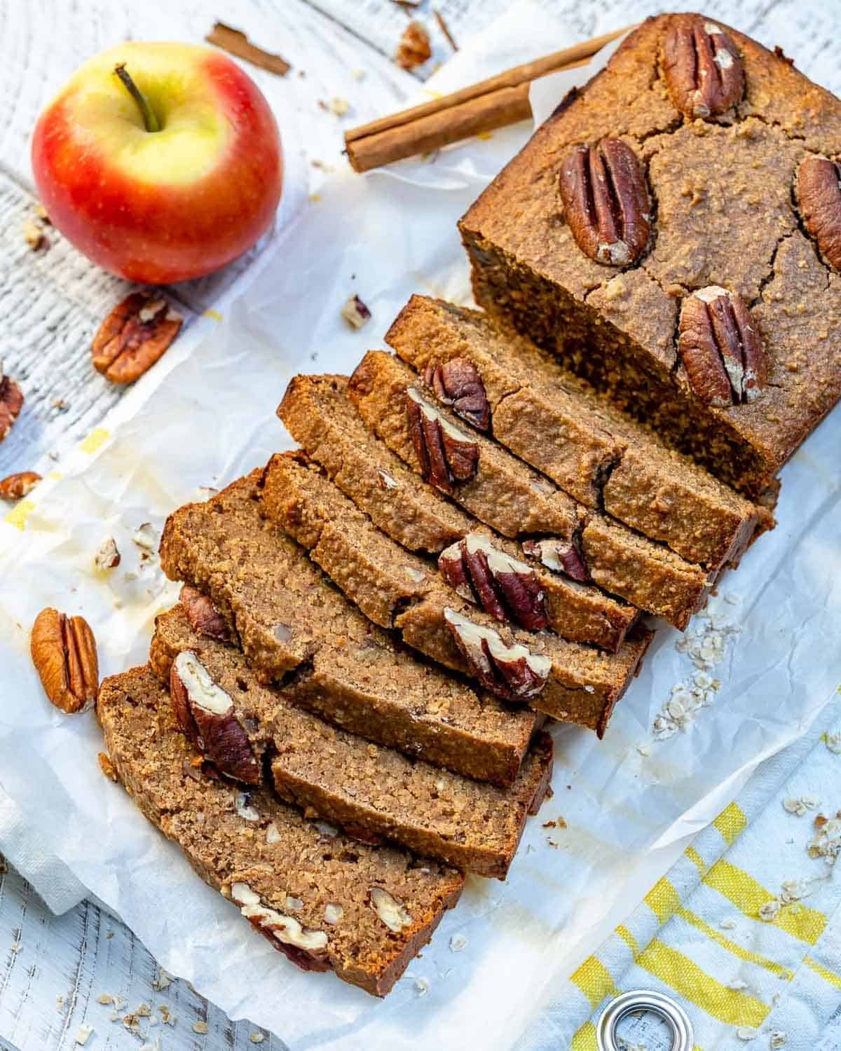sliced apple pecan bread on a parchment paper.
