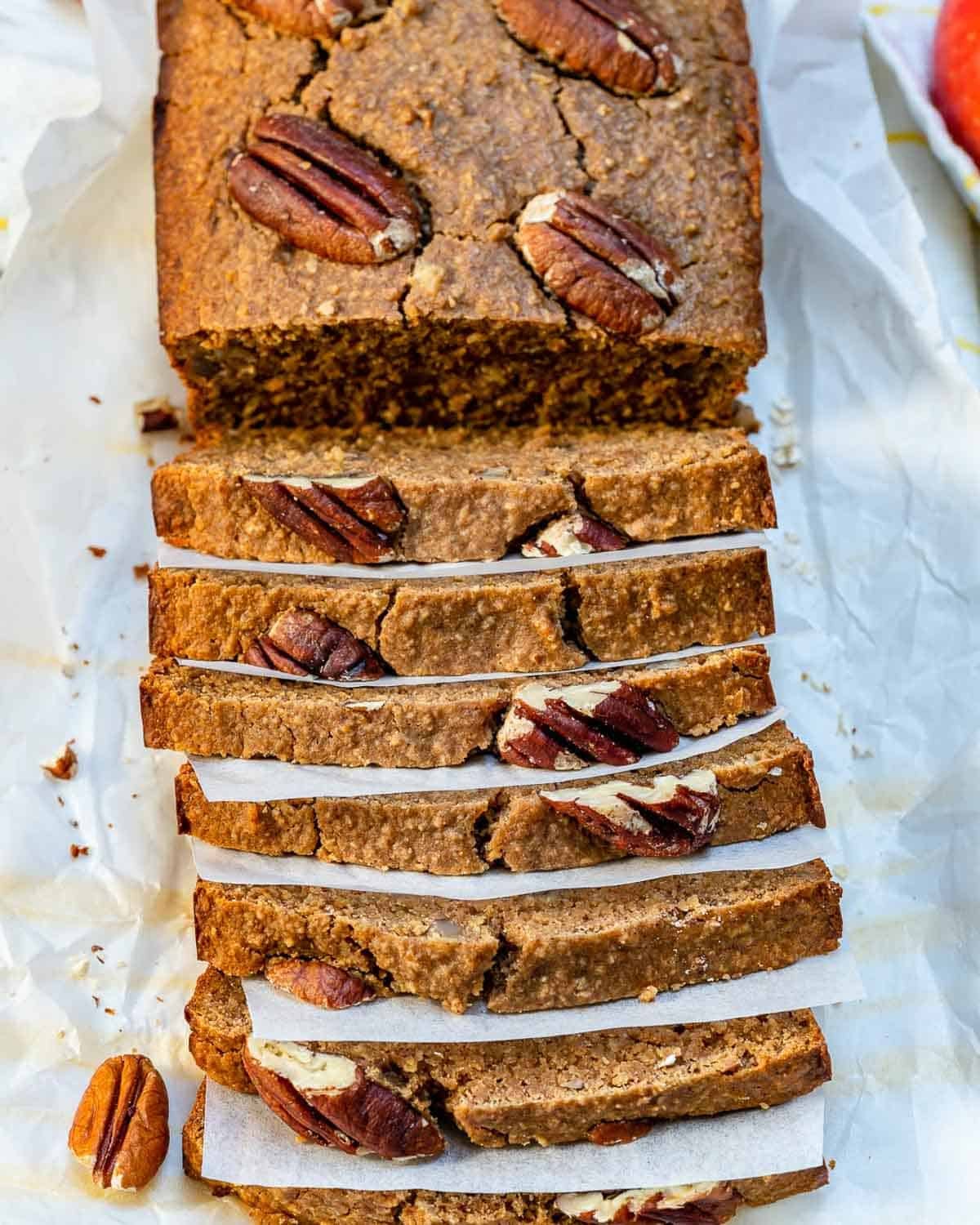 Sliced apple bread on parchment paper.