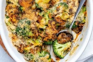 broccoli casserole in a dish with a spoon in it.