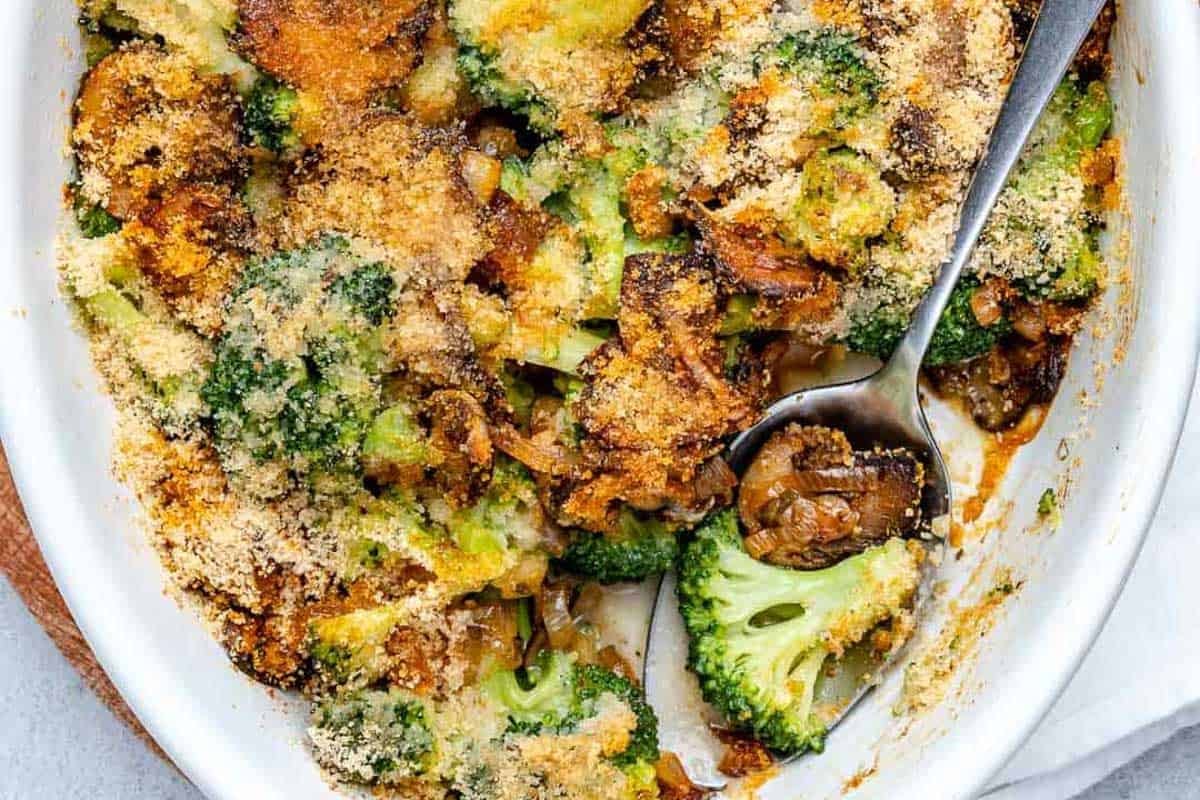 broccoli casserole in a dish with a spoon in it.