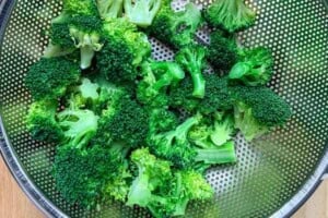 steamed broccoli in a basket.