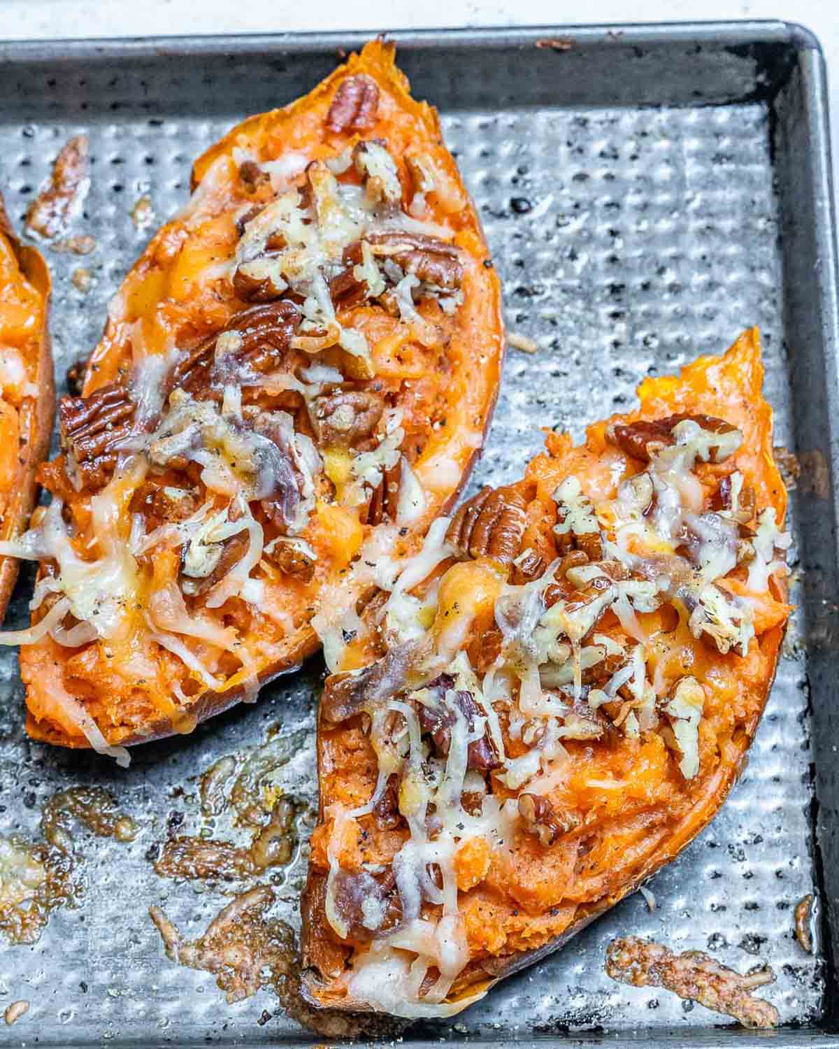 baked and stuffed sweet potatoes topped with pecans and melted cheese.